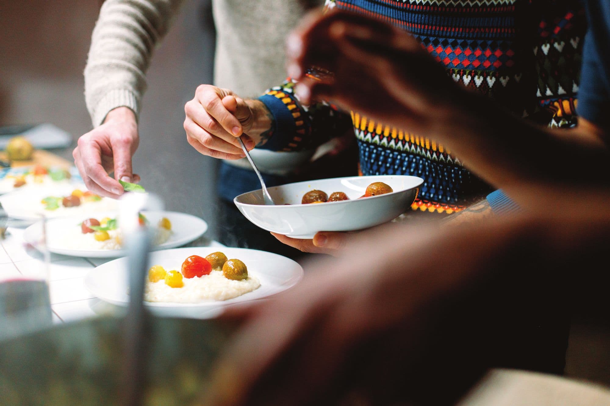 Guests sharing plates of food at a hosted table