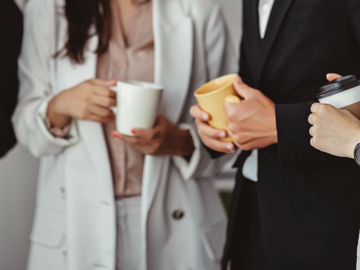 Coffee cups held by hospitality professionals