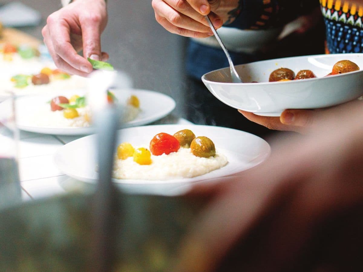 Plates being served at a restaurant table